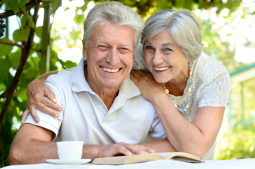 Smiling couple reviewing their Medicare options